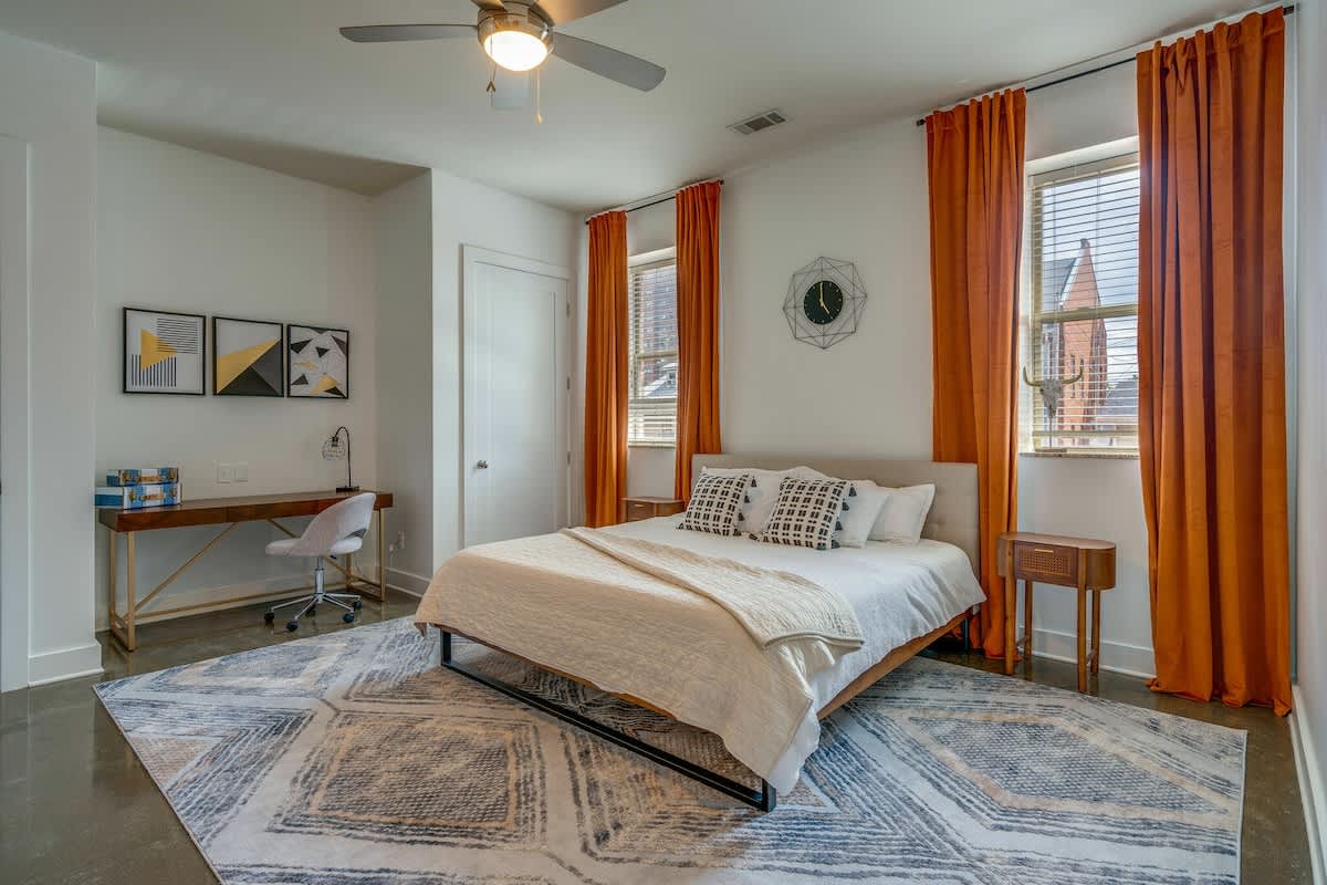Primary bedroom with King bed, work space and lounge area. Includes en-suite bathroom.