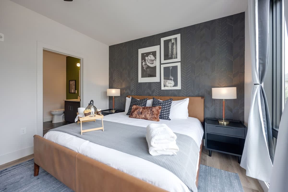 Primary Bedroom with King bed, smart TV, large walk-in closet, and en-suite bathroom.