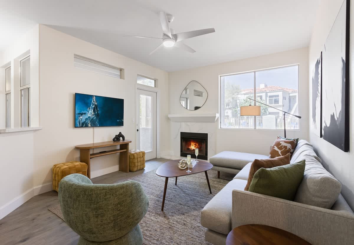 Bright and cozy living space featuring modern furnishings, a Smart TV, and a warm fireplace—perfect for unwinding after a day of exploration.