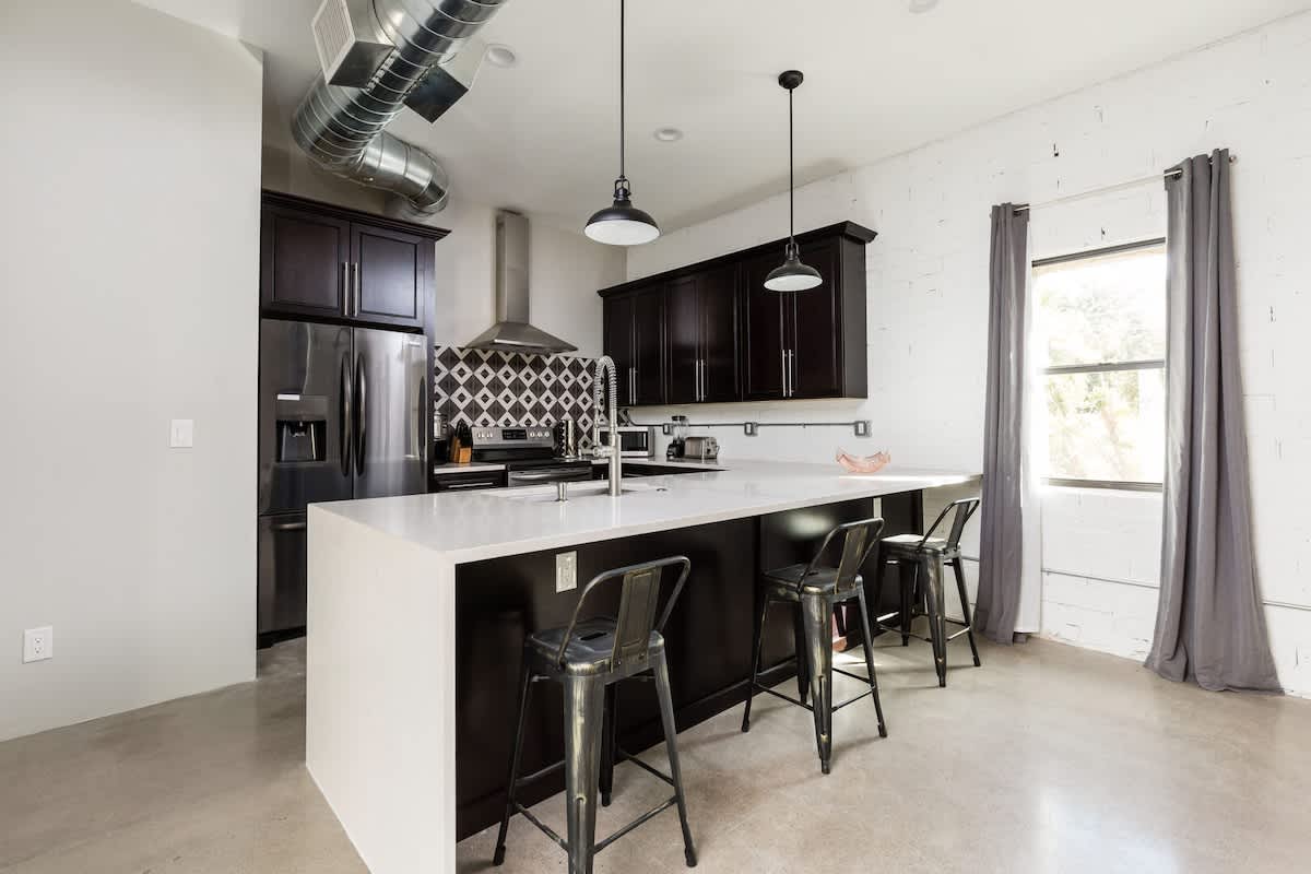 Cook and gather in this modern kitchen, complete with sleek stainless steel appliances and a stylish island with seating for 3—perfect for sharing meals or casual conversations.