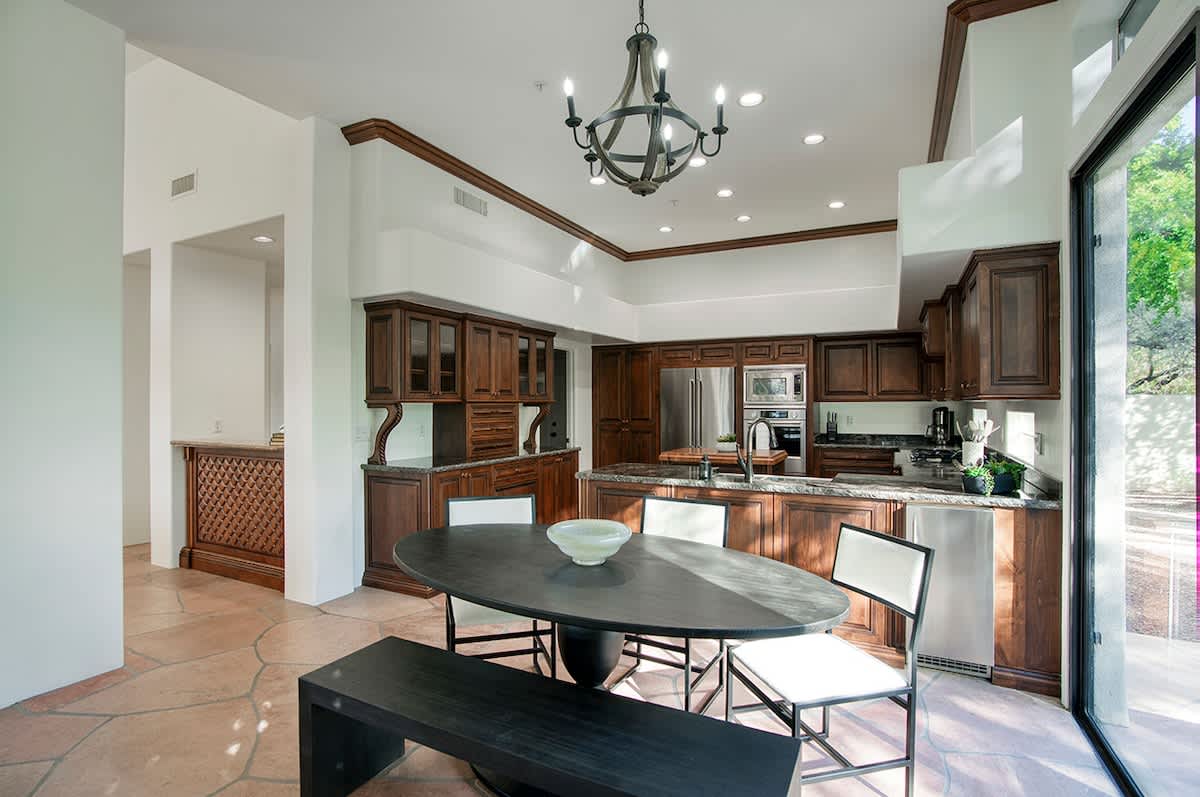 Non-formal dining area for 6 and private access to outdoor patio with outdoor dining table for 6 and built-in BBQ grill.