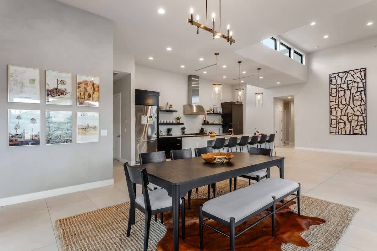 Formal dining area for 8 with a custom light fixture, and private access to the outdoor patio.