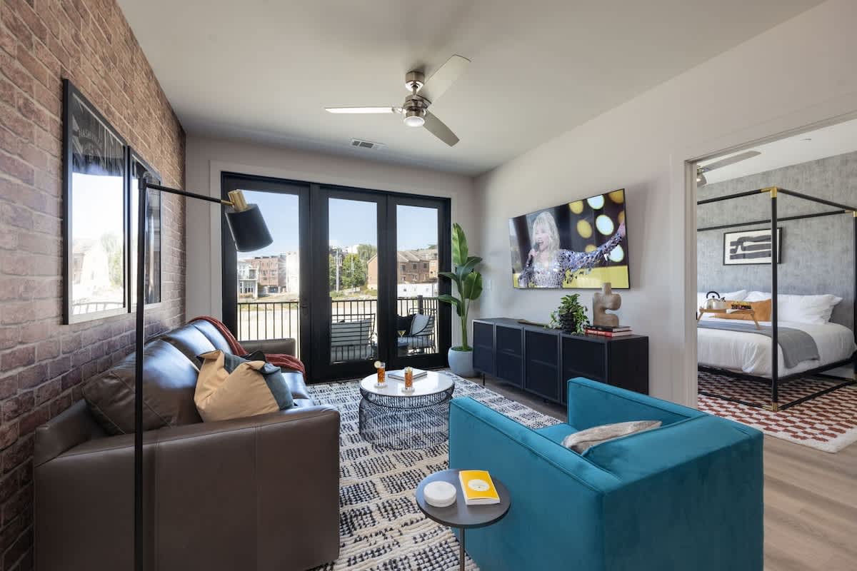 Welcome to a bright and open concept living room that exudes modern elegance. Designer furnishings enhance the sophistication of the space, while a smart TV provides entertainment options and a pull-o
