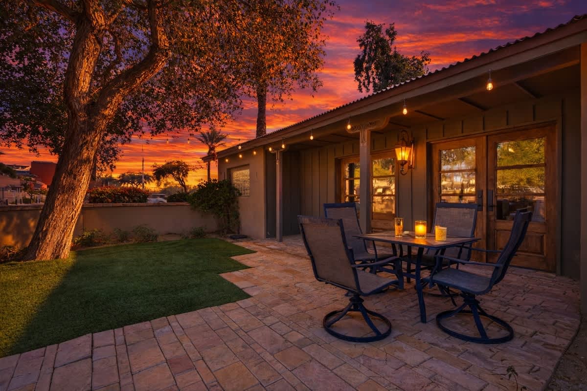 Shared front yard with multiple outdoor dining areas.