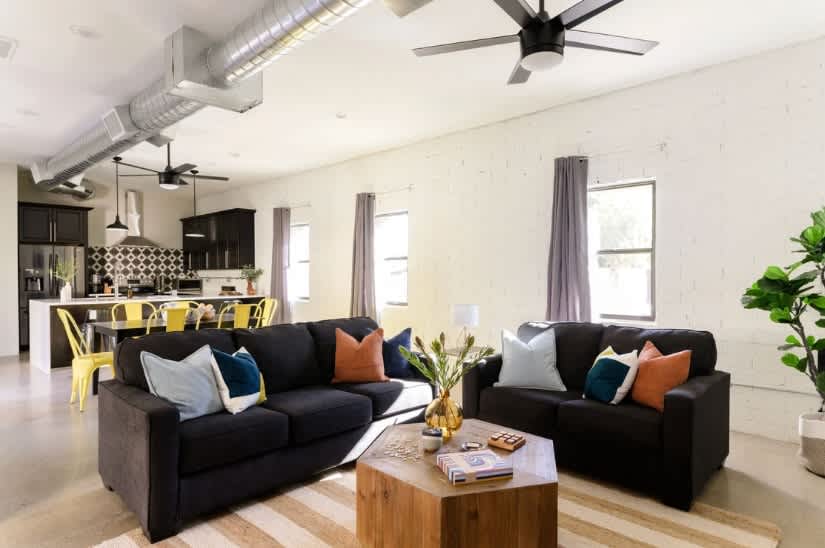 Relax in style with this spacious open-concept living room, featuring a cozy atmosphere and a smart TV for endless entertainment.