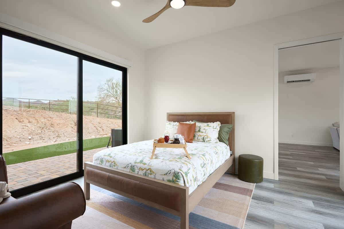 Primary bedroom with a Full bed, smart TV, en-suite bathroom, and access to the private patio.