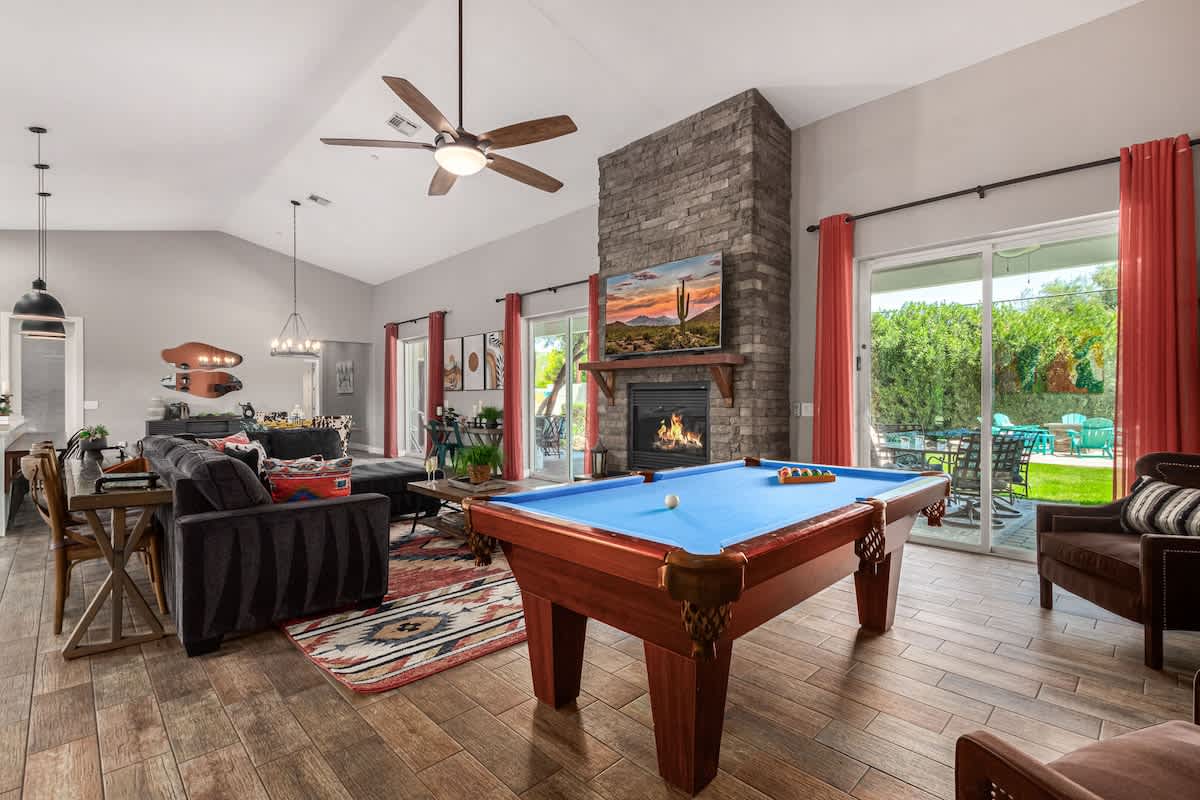 Large open entertaining area a pool table with 15' ceiling, and direct access to the backyard.