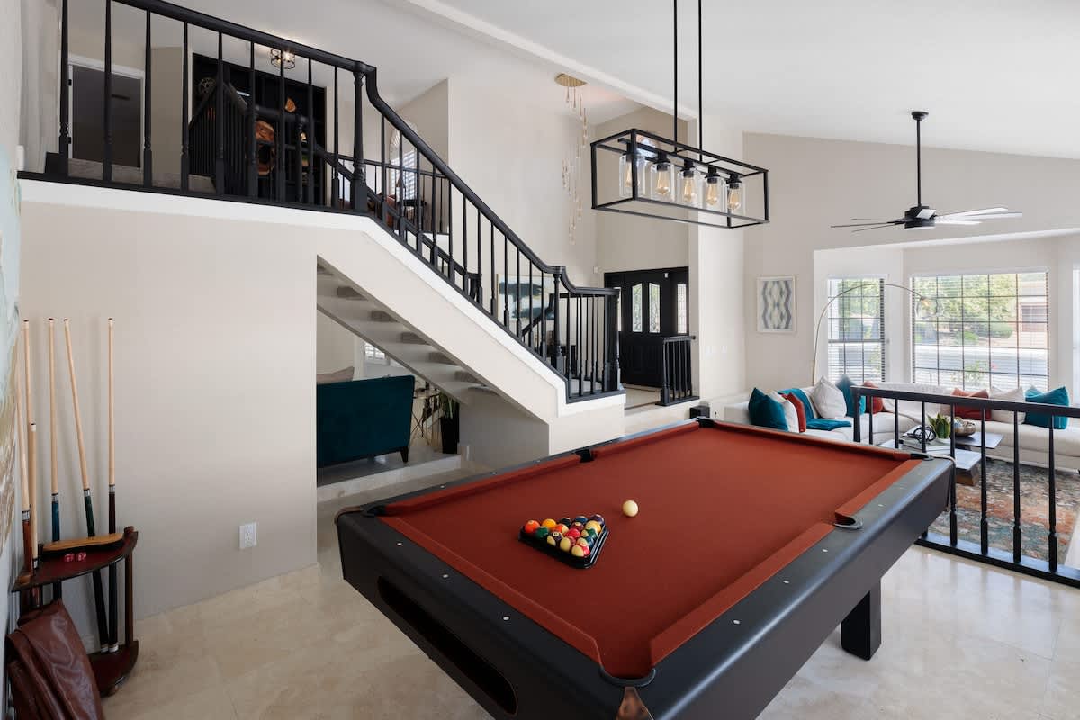 Challenge friends to a game of pool in the lively game room, featuring a high-quality pool table for endless entertainment!