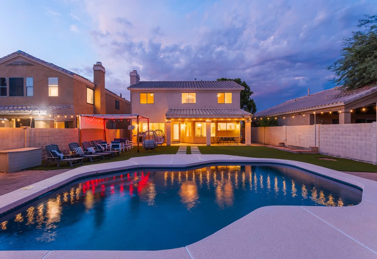 Outdoor canopy with lounge area, heated optional sparkling pool, fire pit, and additional lounging areas.