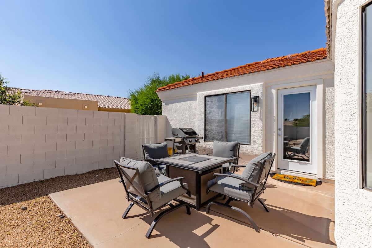 Sparkling heated pool, putting green, fire pit, sun loungers, BBQ, cornhole, and outdoor patio furniture, plus dining area.