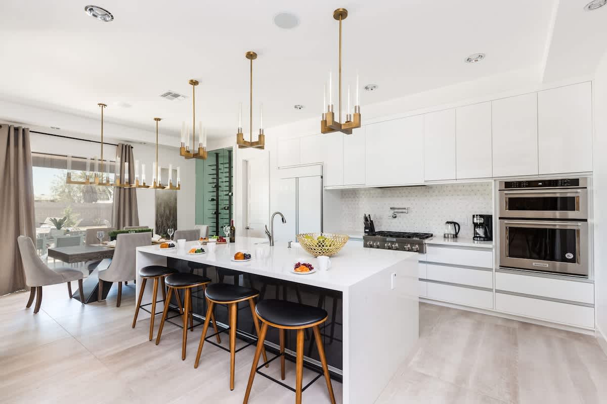 Fully Equipped Chefs Kitchen stocked with all culinary essentials, and stainless steel appliances. Features an oversized island with breakfast bar seating.