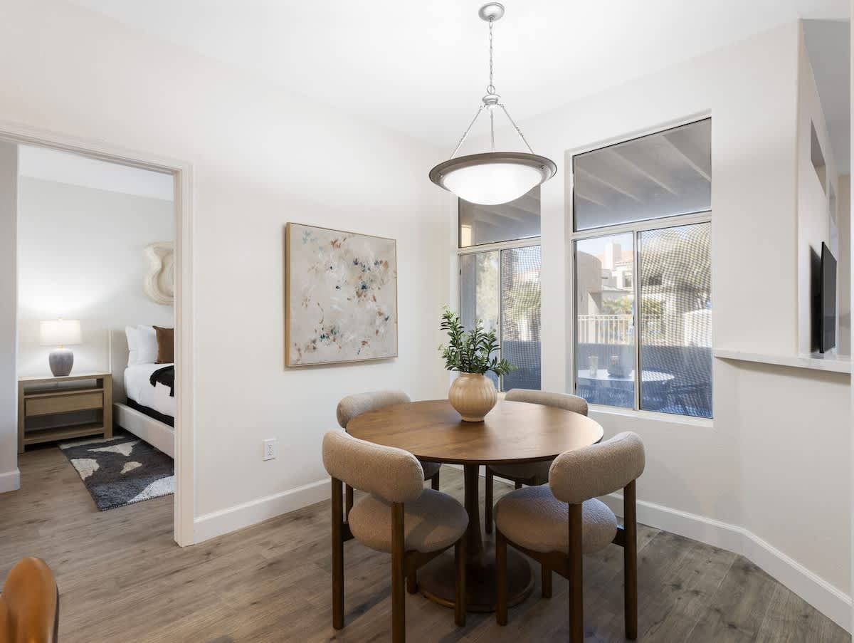 Charming dining area with natural light and seating for four, offering a cozy spot for meals or conversation.