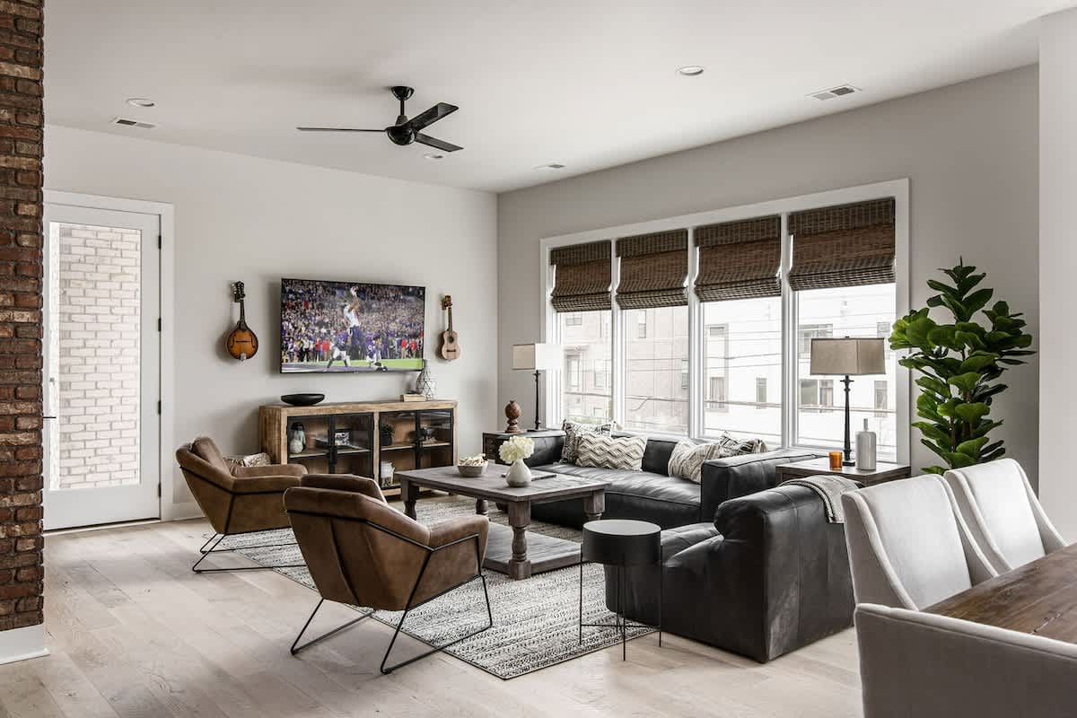 Bright and open living area with flat screen Tv and designer furnishings.