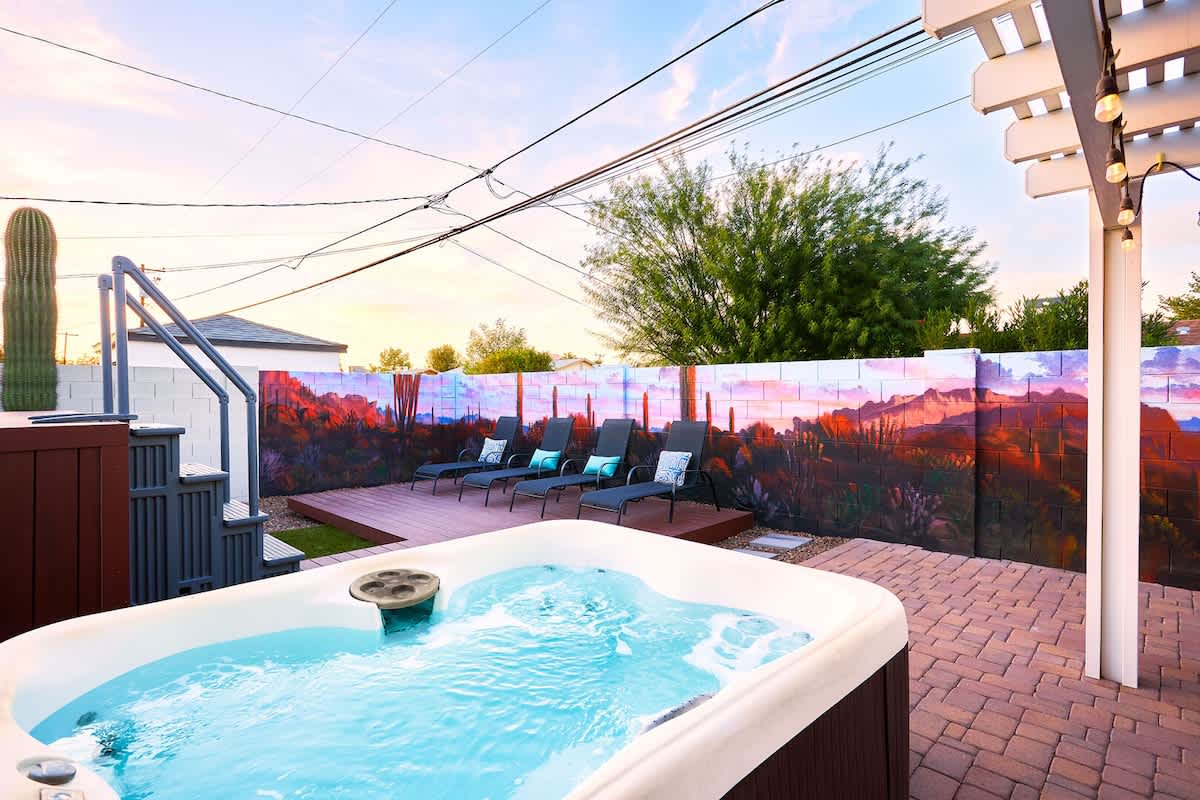 Private backyard patio with a new mural, outdoor dining area, ample seating, hot tub, above-ground pool, lounge chairs, fire pit, BBQ grill, ping pong table, and horseshoe.