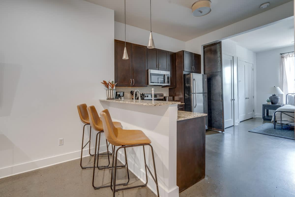 Fully equipped kitchen stocked with basic cooking essentials and complete with bar seating.