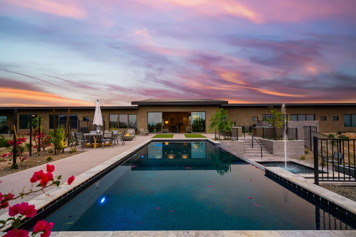 Estate 3 - Stunning private oasis featuring a sparkling heated infinity pool and spa with sun loungers, a patio with a BBQ grill, multiple lounge areas, and fire pits surrounded by unparalleled desert