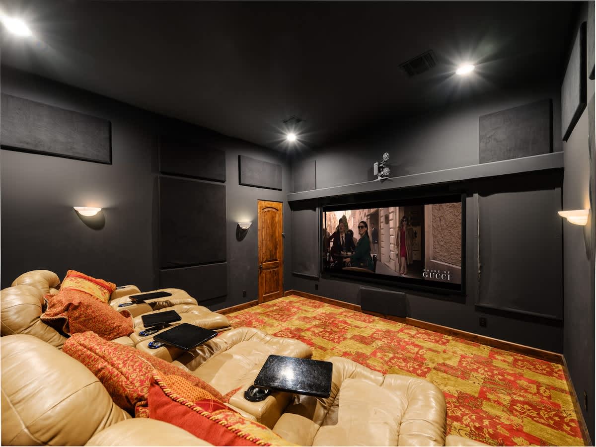 Enjoy a private movie theater complete with comfortable recliner seating for the ultimate cinematic experience.