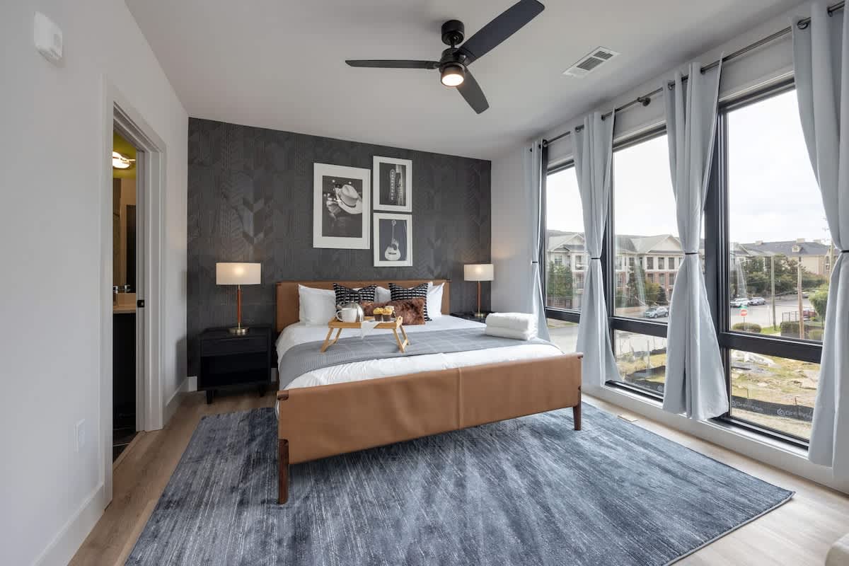Unit 1: Primary Bedroom with King bed, smart TV, large walk-in closet, and en-suite bathroom.
