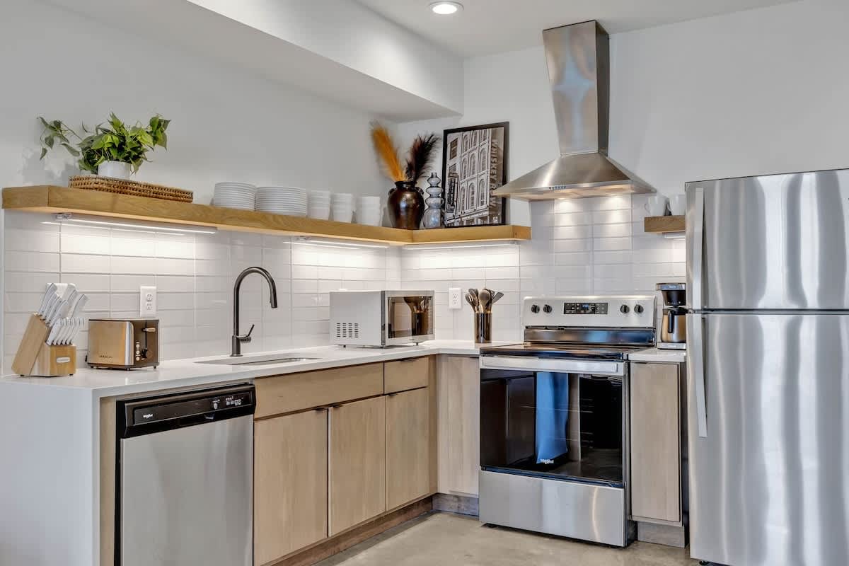 Fully equipped kitchen stocked with all culinary essentials and boasting stainless-steel appliances.