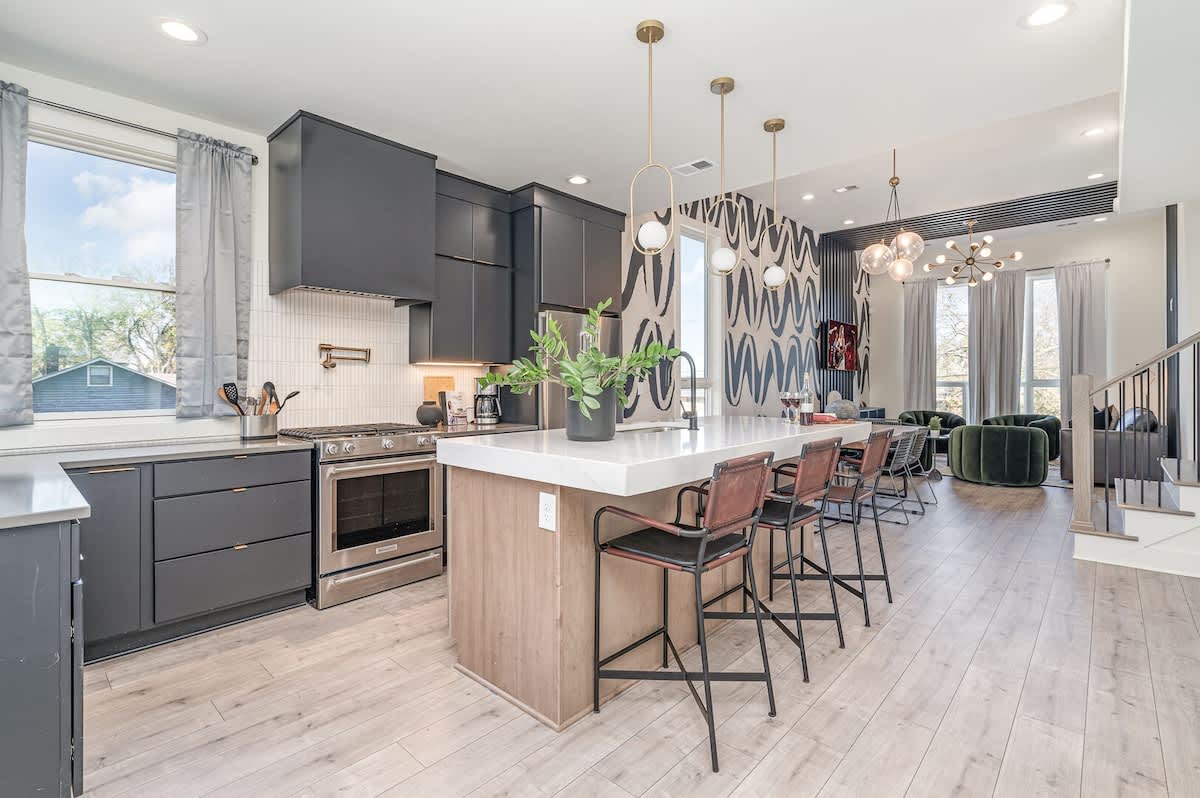 The fully equipped kitchen is stocked with all culinary essentials and boasts brand-new stainless-steel appliances with an oversized kitchen island offering bar seating. (1st Floor)