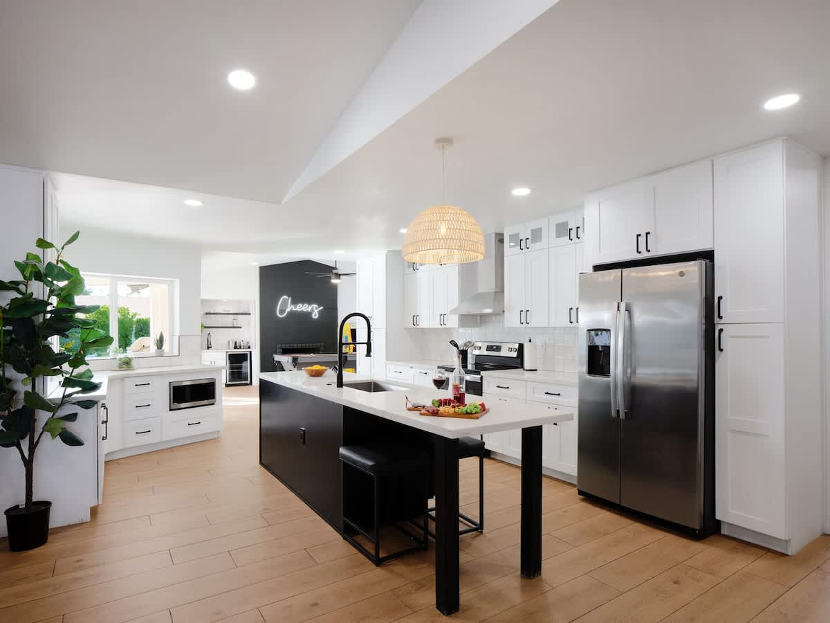 Fully equipped kitchen with stainless steal appliances and a kitchen island with bar seating for 2 guests.