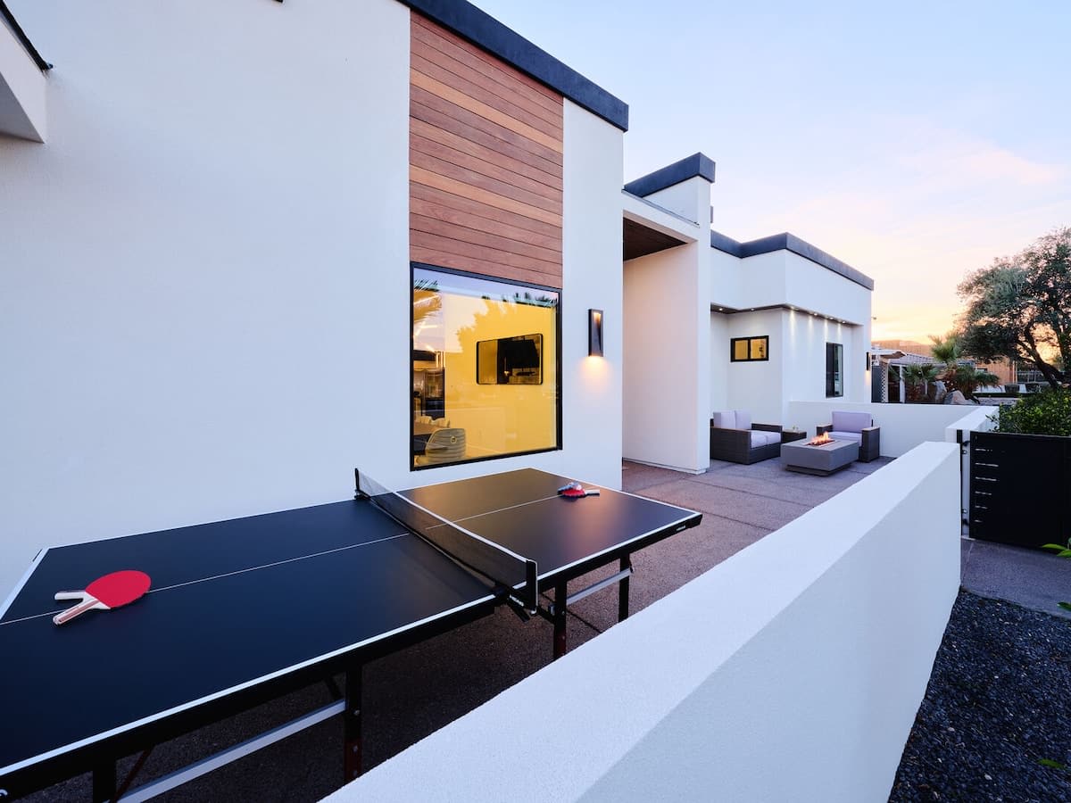 Front Patio featuring a Ping Pong table for friendly competition, and a cozy fireplace for those cool desert nights.