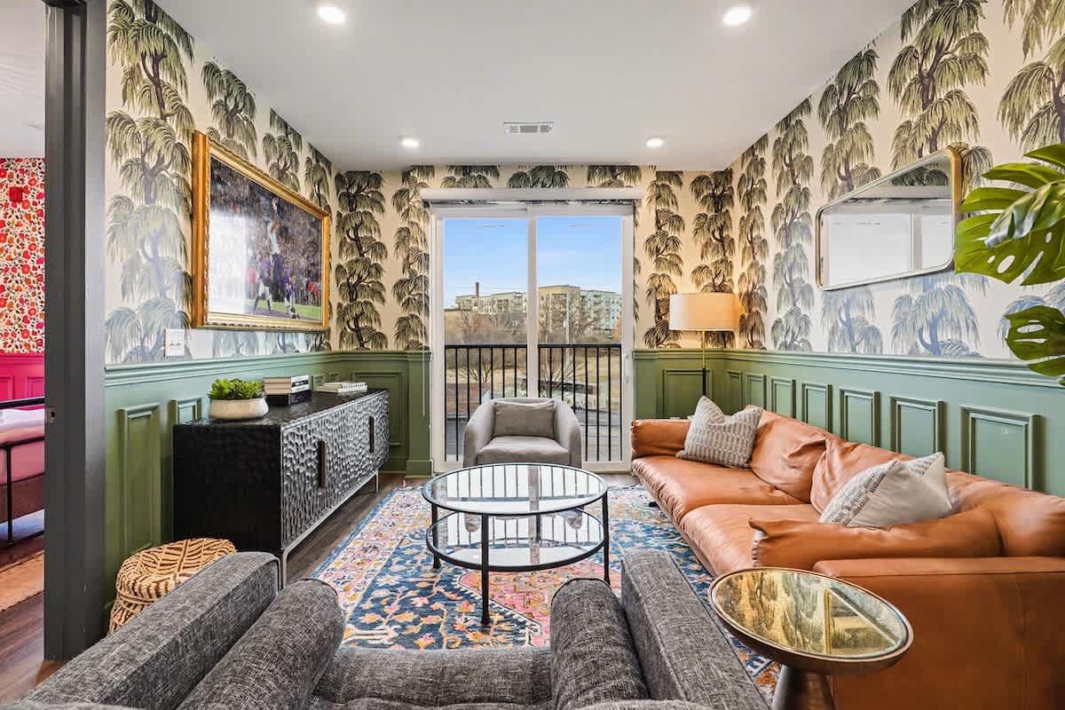Bright and open living space featuring a picture frame smart TV and cozy furnishings.