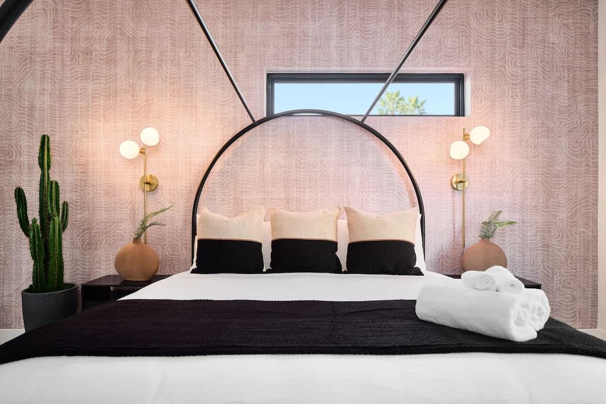 Unit 1: 2nd Bedroom featuring a King bed, a Smart TV, closet space, and an en-suite bathroom.