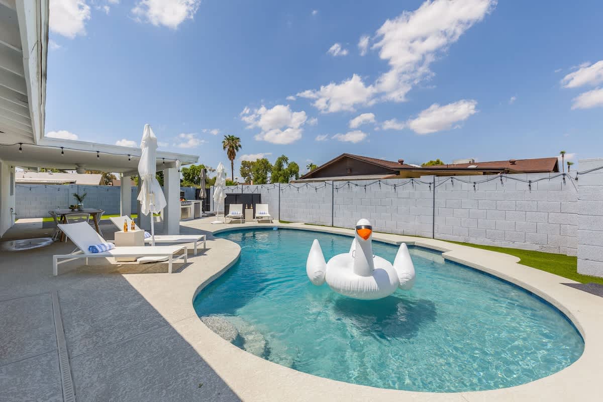 Private backyard with pool, built in grill, putting green and lounge areas