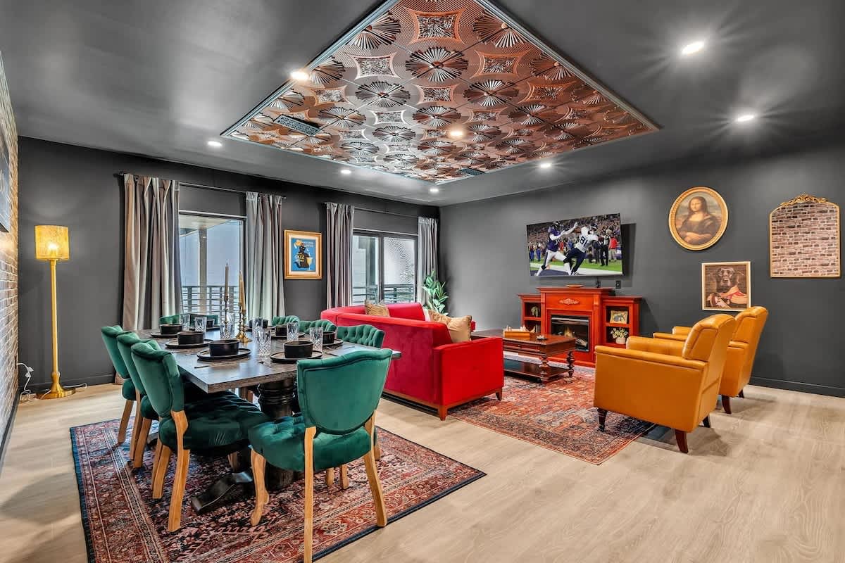 Unit 2: Open-floor living space featuring a smart flat-screen TV and designer furnishings. This inviting area effortlessly connects the dining space with the well-appointed kitchen.