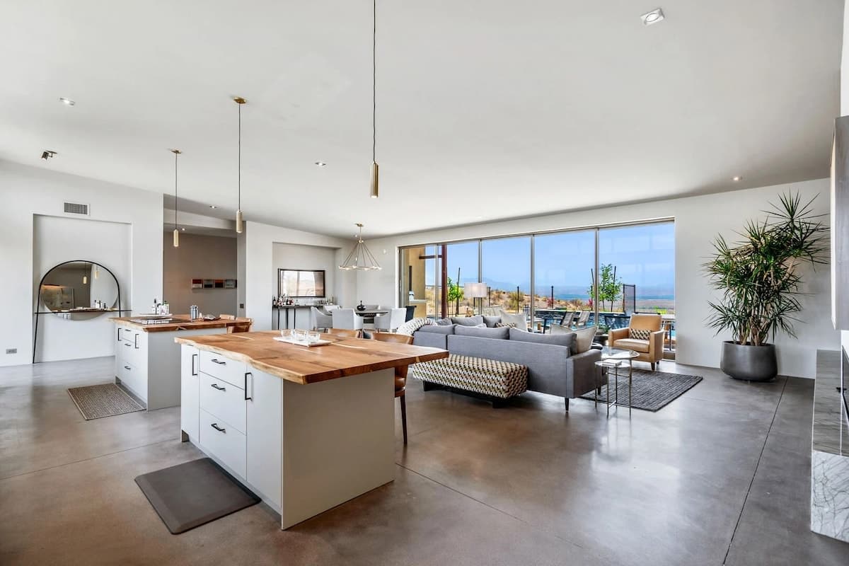 The fully equipped luxury kitchen is stocked with all culinary essentials and features high-end stainless-steel appliances, 2 kitchen islands, 2 breakfast tables, 6 person dining tables, and a wet bar
