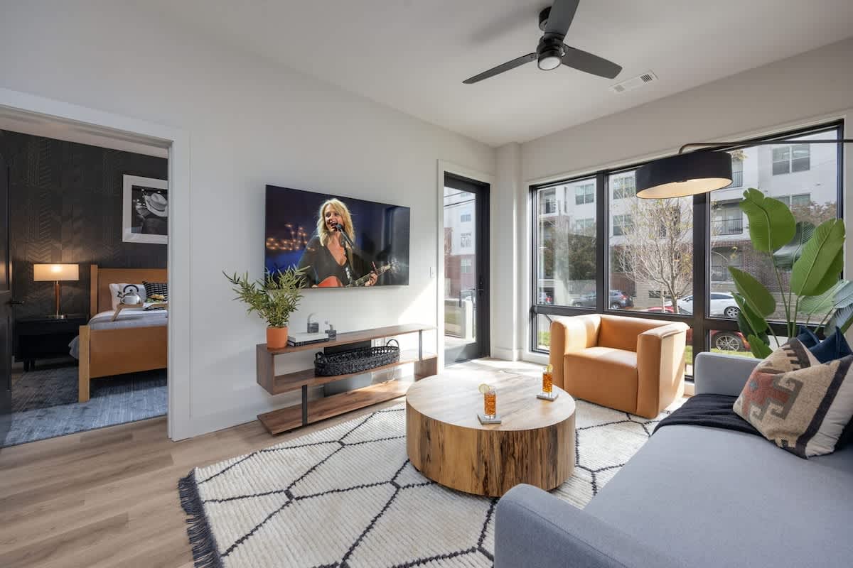 Bright living room with comfortable seating, pull out sofa, smart TV, complete with designer decor.