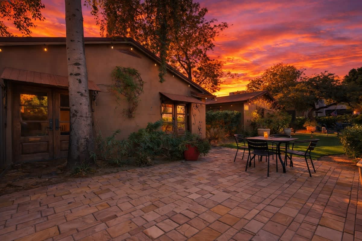 Shared front yard with multiple outdoor dining areas.