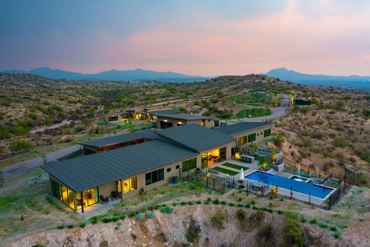 Estate 3 - Stunning private oasis featuring a sparkling heated infinity pool and spa with sun loungers, a patio with a BBQ grill, multiple lounge areas, and fire pits surrounded by unparalleled desert