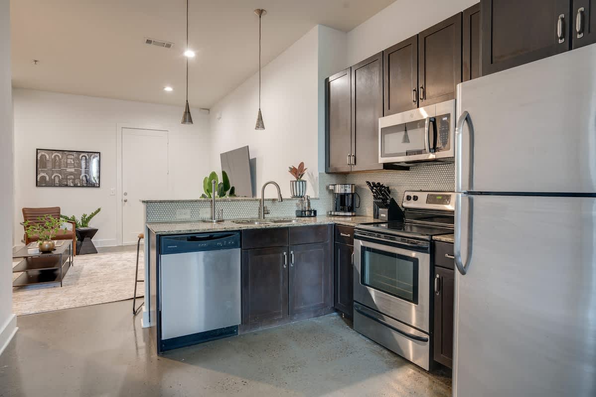 Fully equipped kitchen stocked with basic cooking essentials and complete with bar seating.