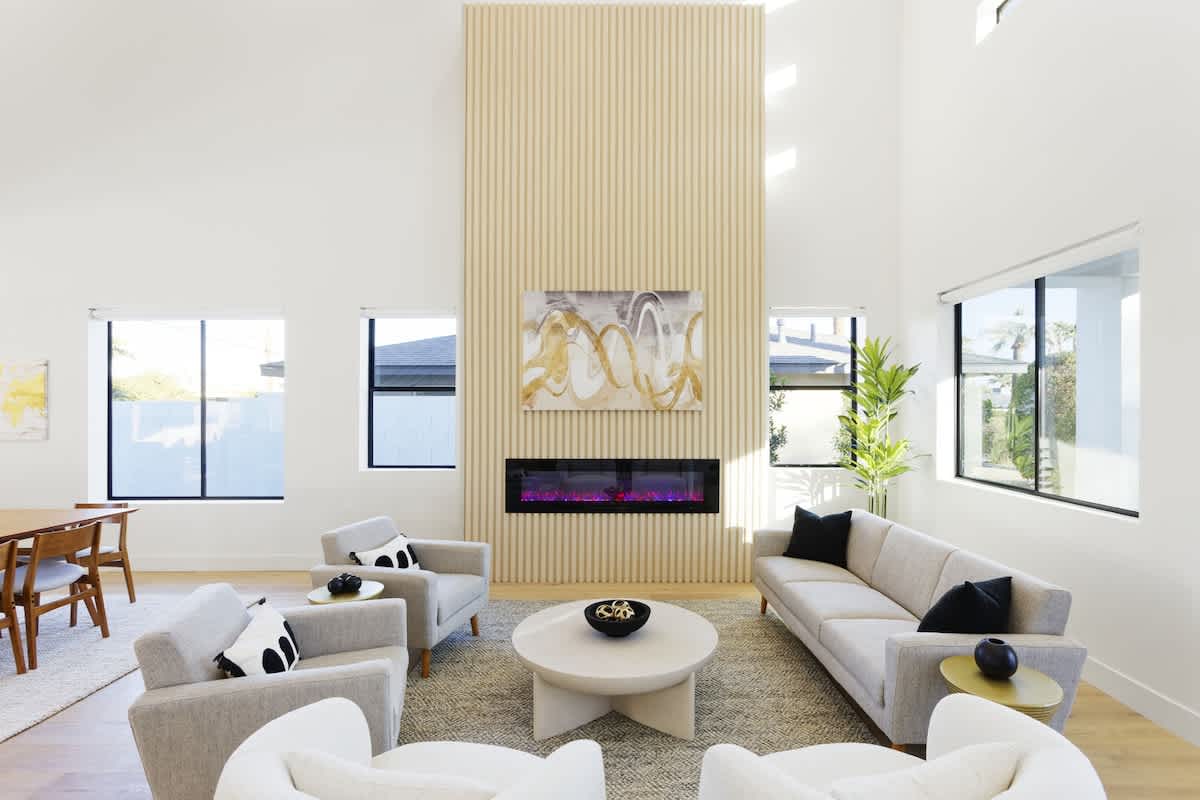 Second Living area next to the dining area featuring designer furnishings and a color-changing fireplace.
