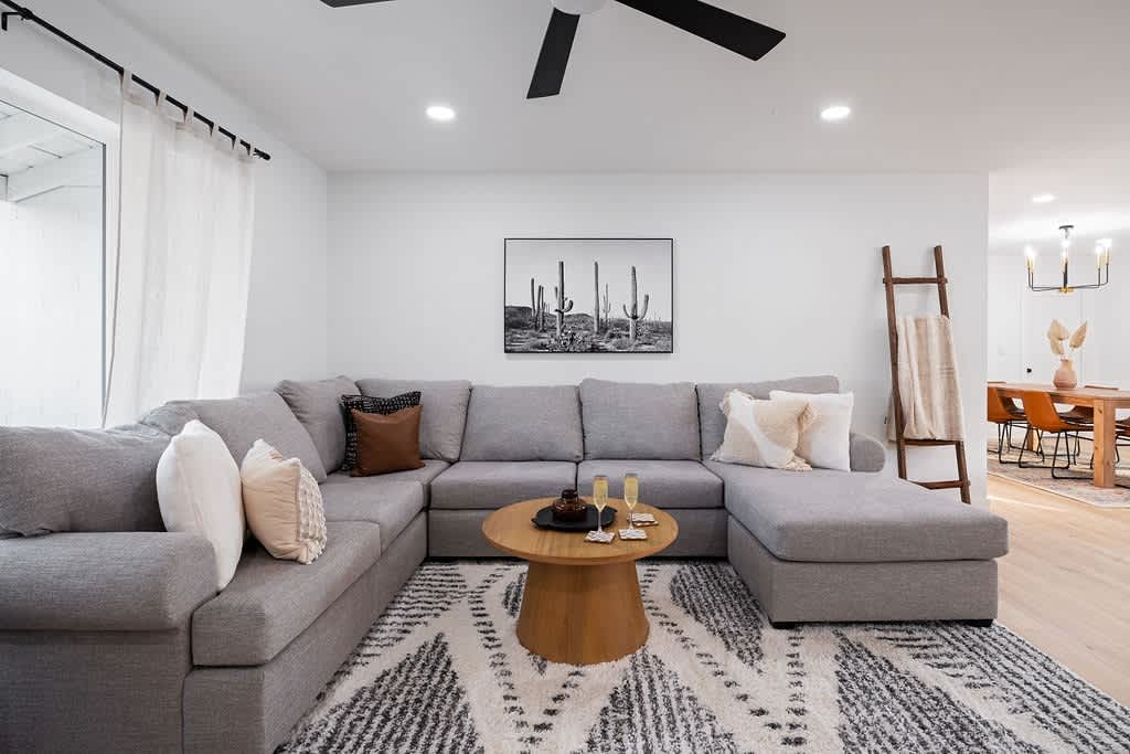 Warm Designer Furnished Living Room featuring Smart Flat Screen TV and Cozy Oversized Sectional