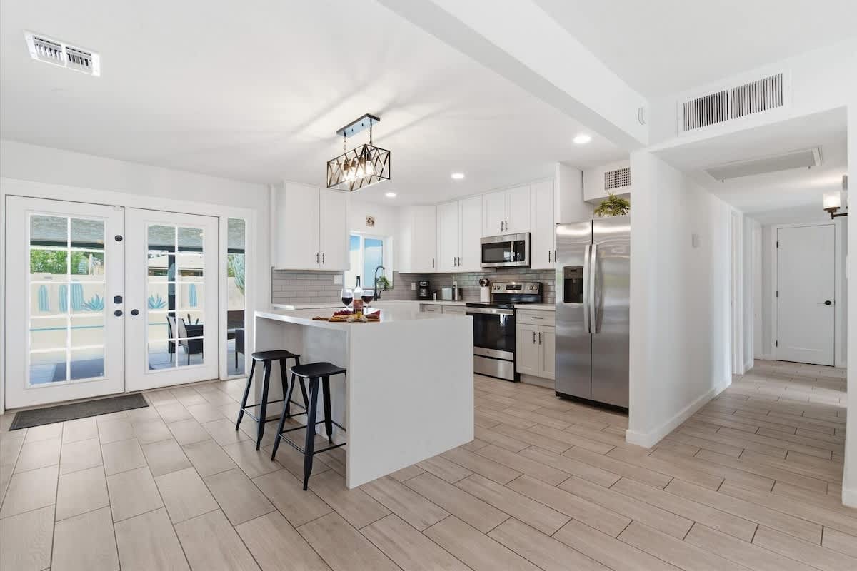Fully equipped kitchen with stainless steal appliances and a kitchen island with bar seating for 2 guests.