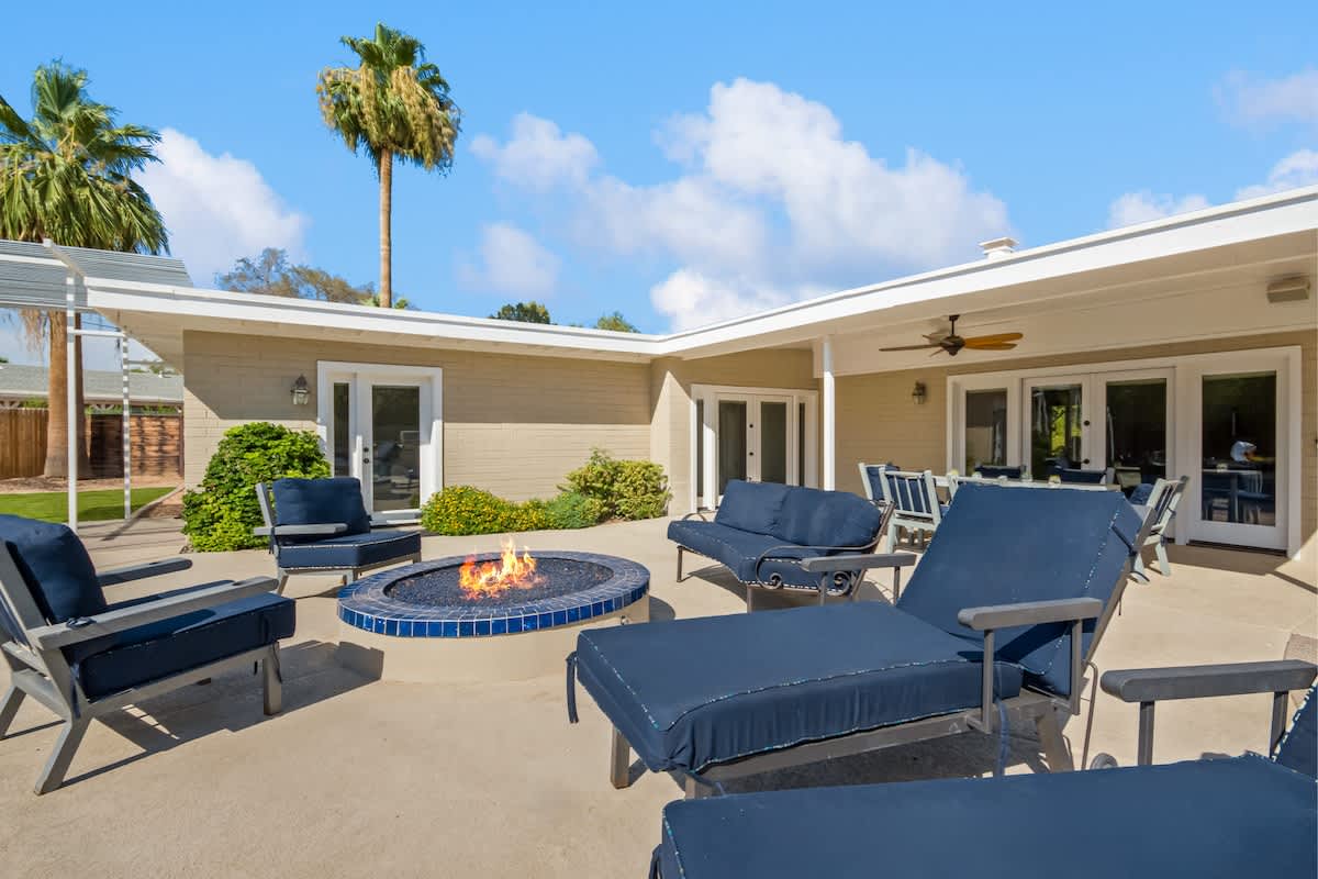 Backyard lounge area featuring a large fire pit perfect for those cool desert nights.
