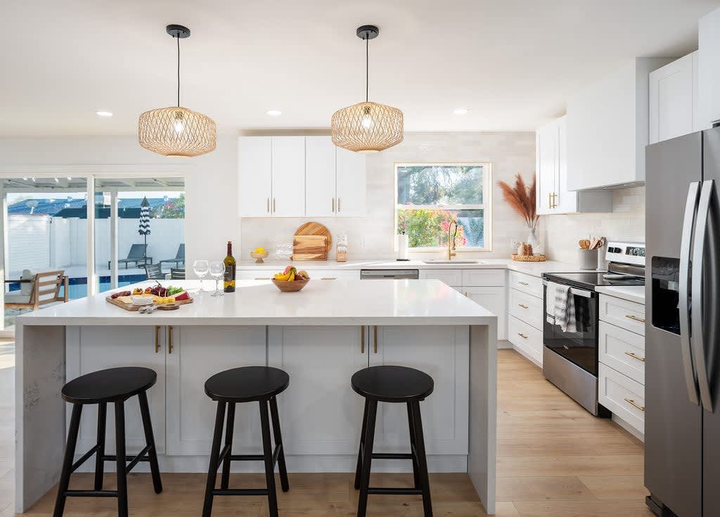 Bright Modern Fully Equipped Kitchen Stocked with your Basic Cooking Essentials featuring Stainless-Steel Appliances.