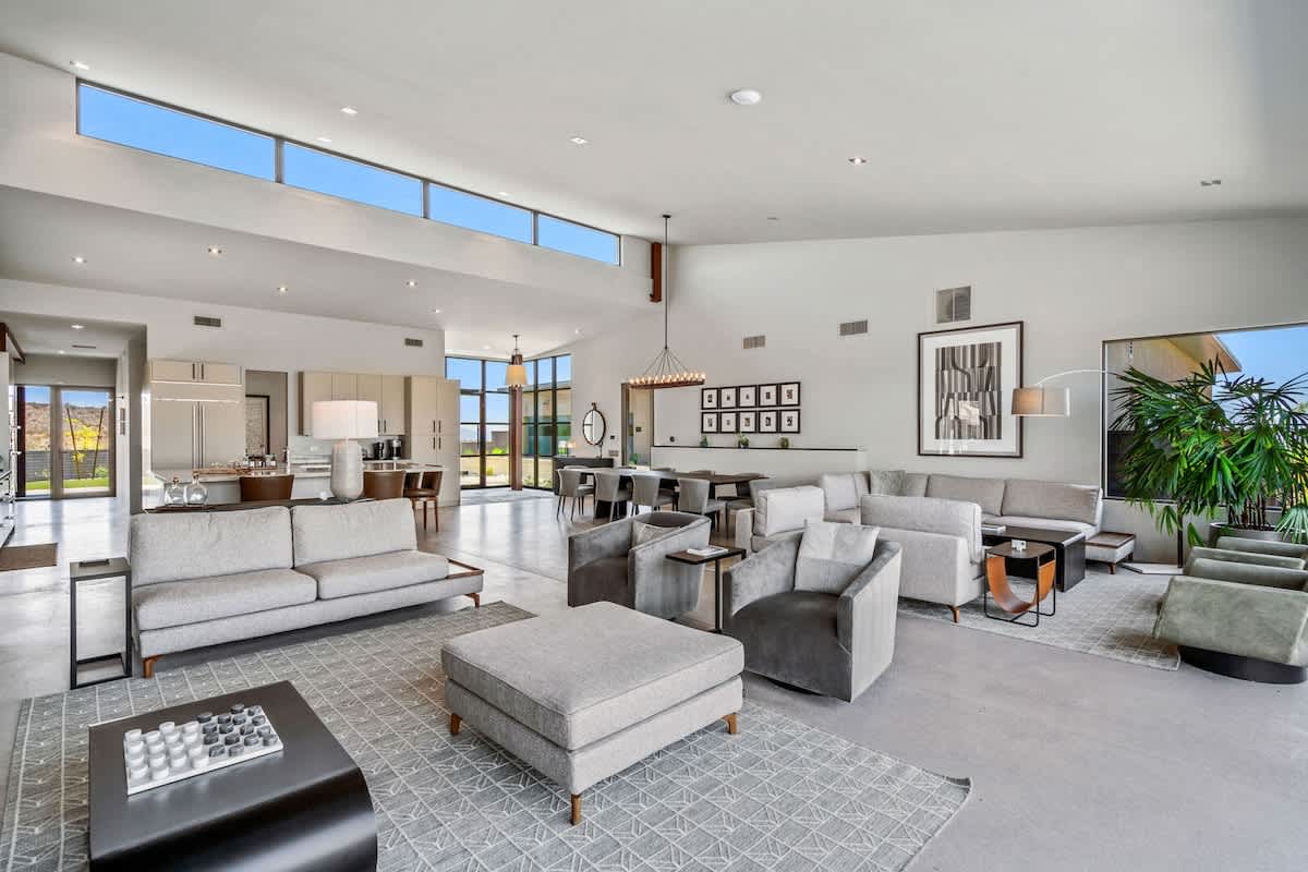 Spacious, light and bright living room featuring an electric fireplace, wet bar, Smart TV and designer furnishings.