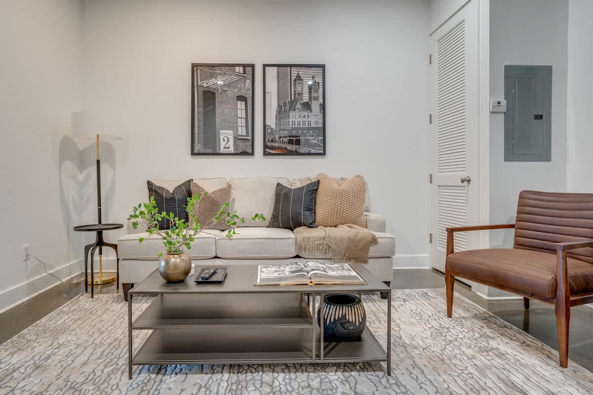 Open concept living area with smart TV and designer furnishings.
