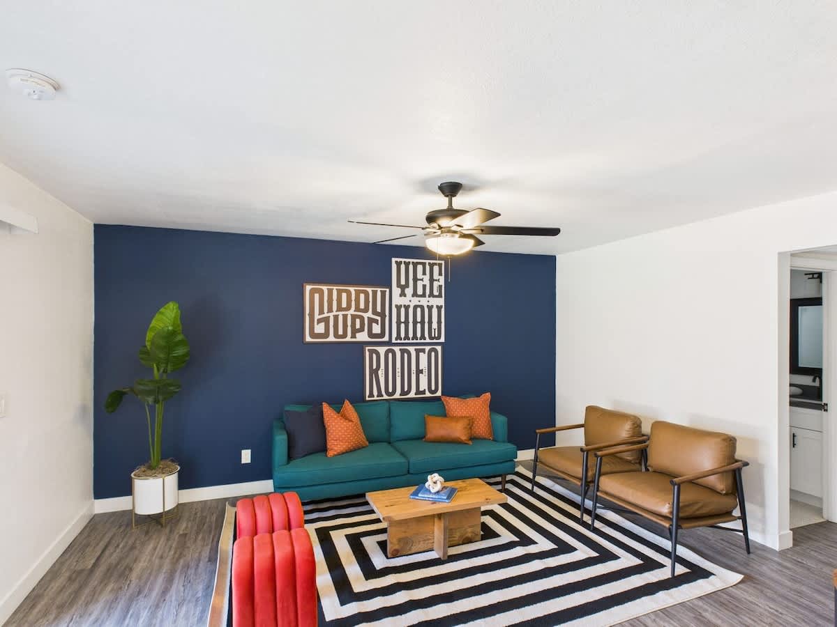 Unit 1: Bright and open living area with a smart TV, designer furnishings and a dining table with seating for 2 guests.