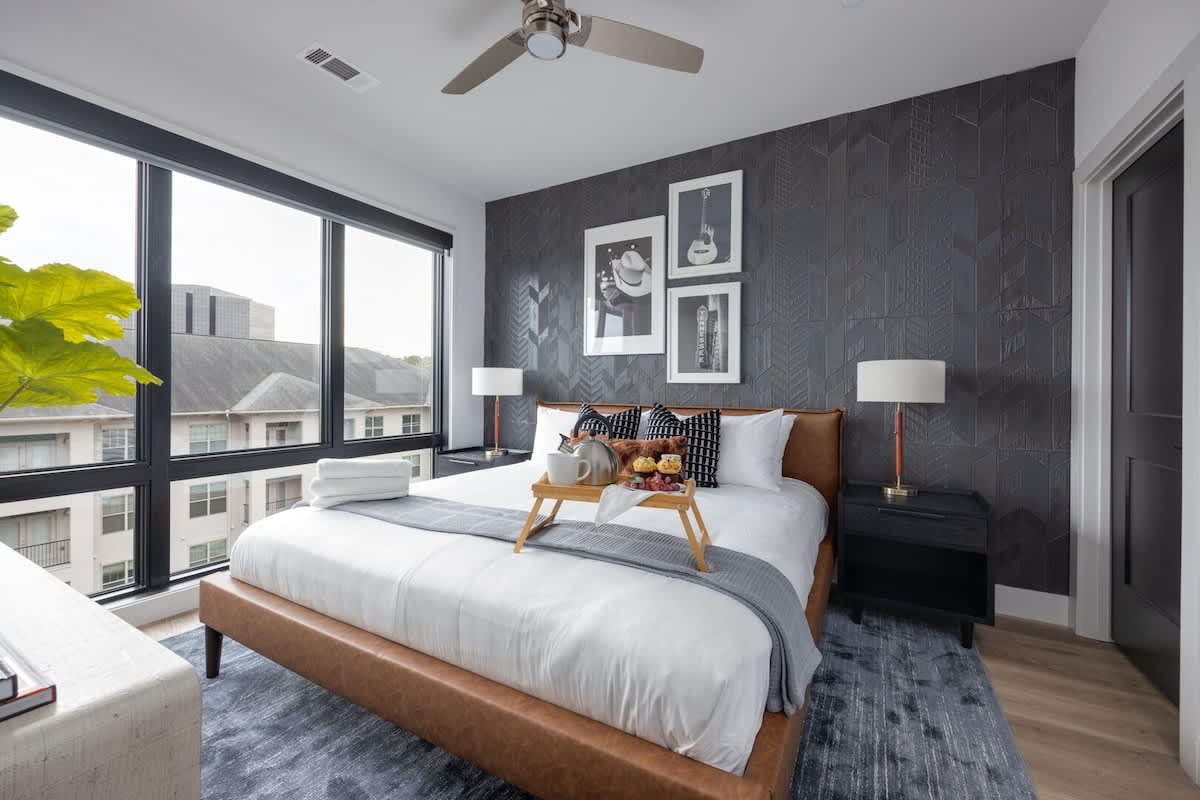 Unit 2: Primary Bedroom with King bed, smart TV, walk-in closet, and en-suite bathroom.