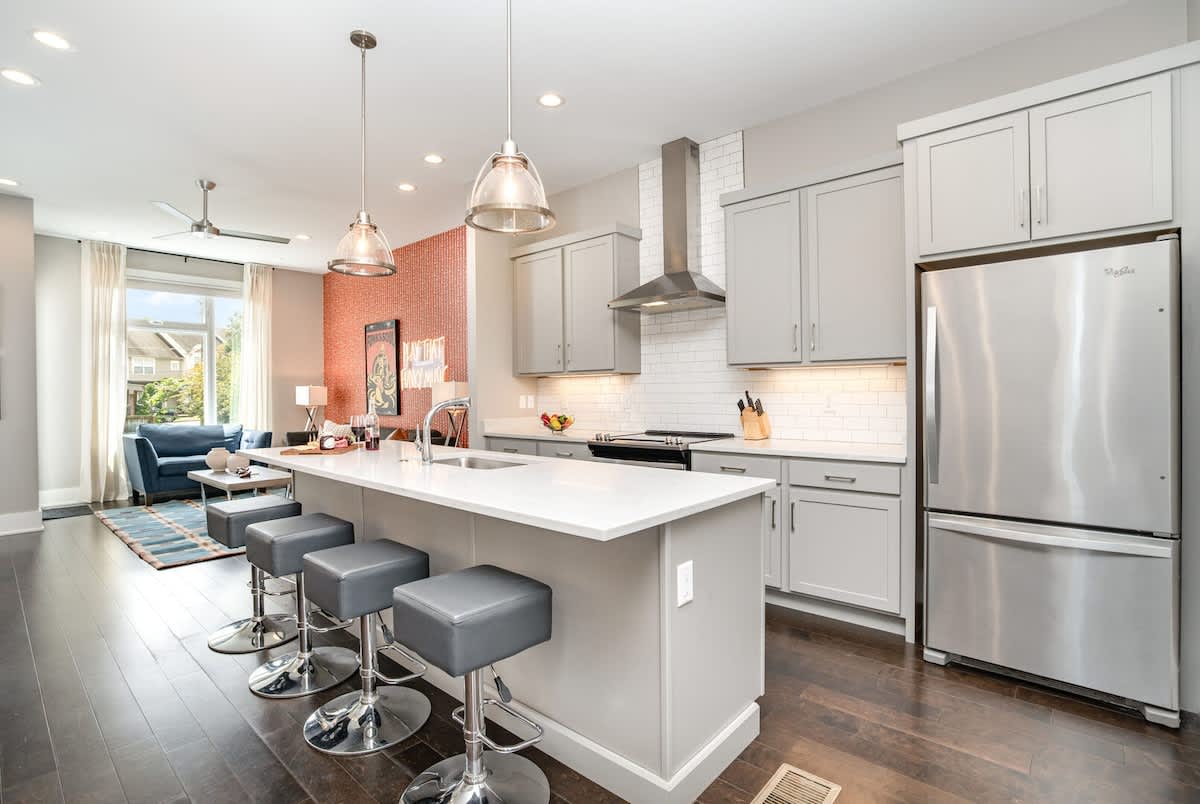2nd Floor: Fully Equipped Kitchen with stainless steel appliances and a spacious island with seating for 4 guests.