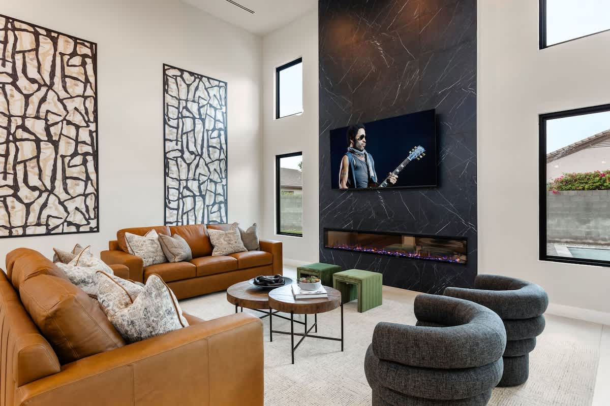 Unit 1: Professionally designed modern styled living area, 20 ft vaulted ceilings, large electric fireplace, large smart TV, and complete with designer furnishings.
