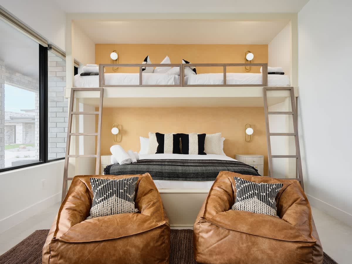 5th Bedroom featuring 2 Twin beds over a King bed with a Smart TV, closet space, and bedroom furnishings.