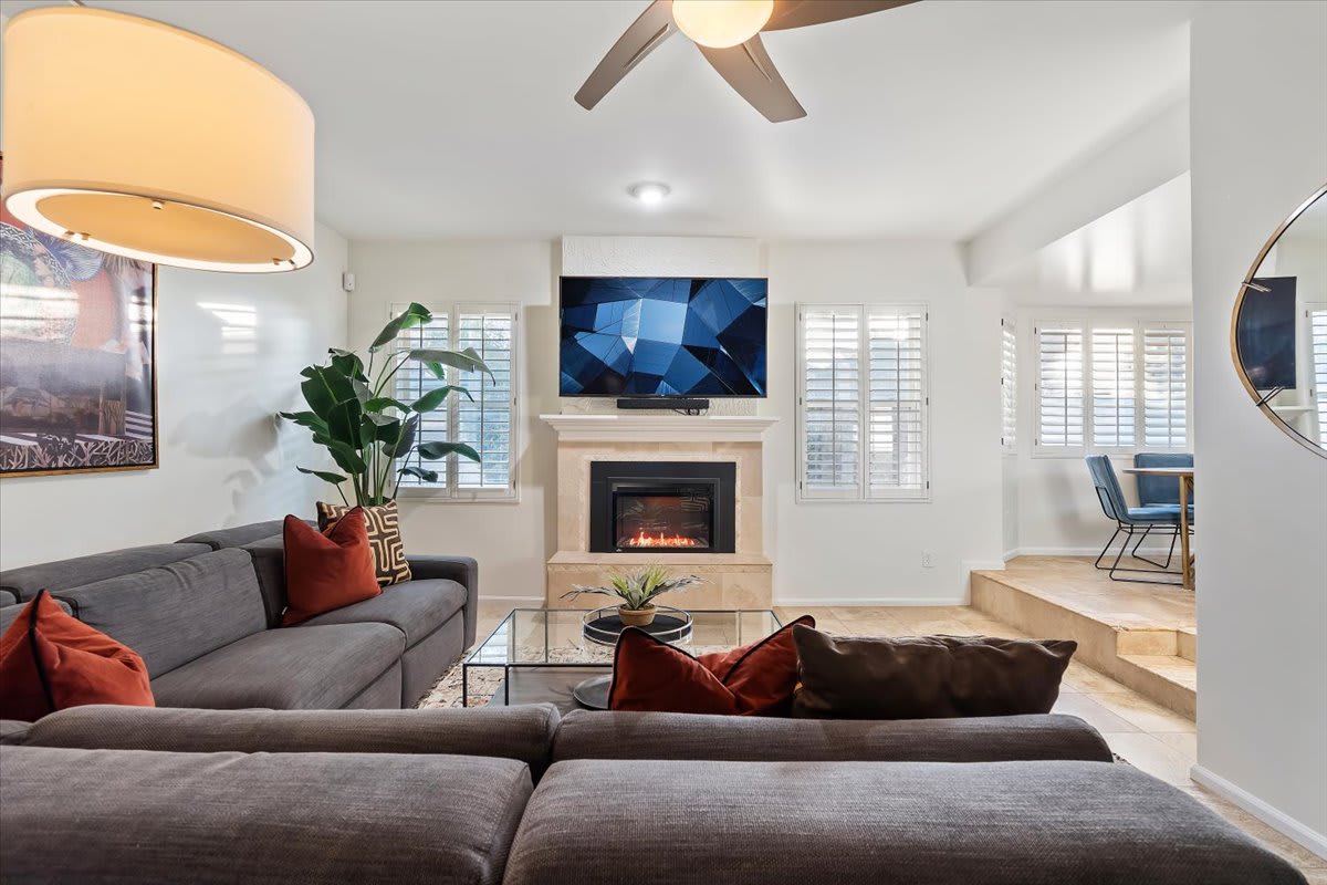 2nd living room with electric fireplace, smart TV, and lounge area.
