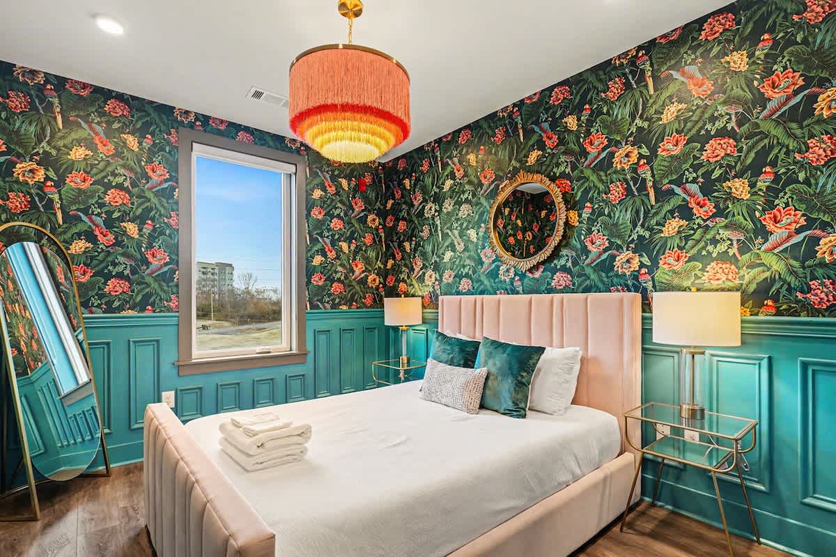 3rd Bedroom featuring a Queen bed with a smart TV, themed decor, and a walk-in closet.