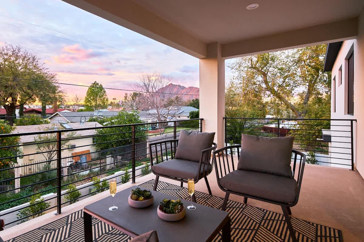 (2nd Floor) Covered balcony off the secondary living space with seating and stunning views of Camelback Mountain.
